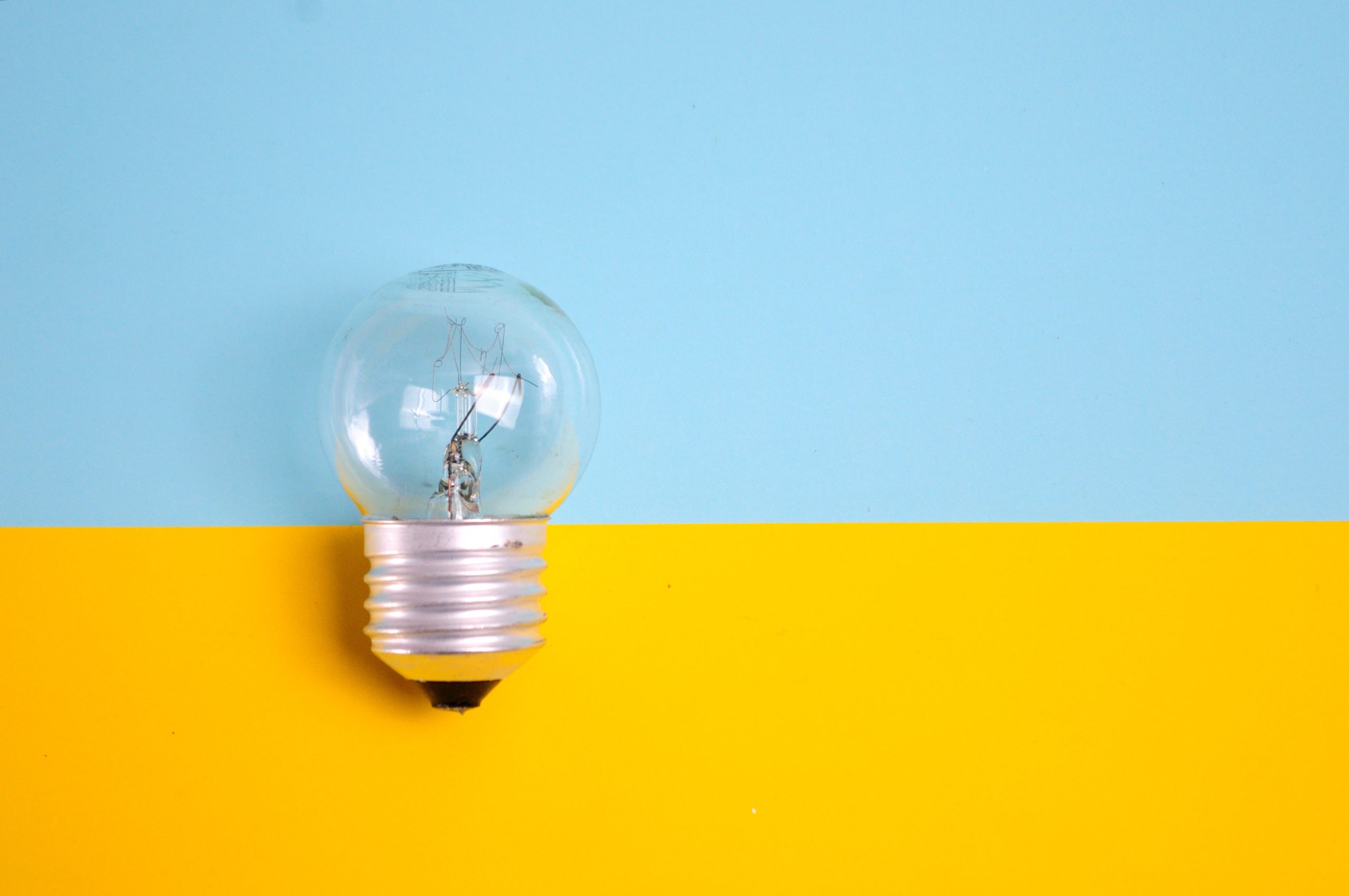 Image of light bulb against a blue and yellow background